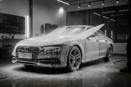 Sedan covered in thick foam during an exterior detail wash